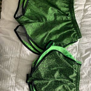 two pairs of green nike running shorts